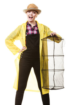 Happy woman holding empty fishing keepnet