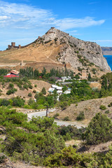 Fototapeta premium View of the resort town of Sudak on the coast of the Black sea from Genoese fortress on the mountain Cenevez Qaya