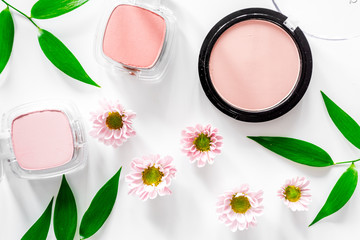 Makeup. Eyeshadow and blush on white table background top view