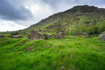 Fototapeta na wymiar Iceland - Green mountain and huge rocks
