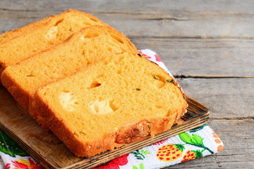 Pumpkin cheese bread slices. Pumpkin bread with cheese filling on a wooden board. Healthy and tasty bread recipe. Closeup