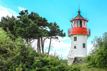 Old lighthouse Gellen and pine trees. Hiddensee, Baltic Sea.