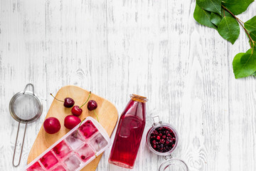 Cranberry morse with cherry and pulm on wooden table background top view copyspace © 9dreamstudio