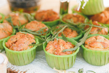 Snack of cheese cake with greens in small cupcake form.