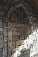 Travel to Montenegro. Architecture, facade elements and details of the ancient masonry with carved bas-reliefs.