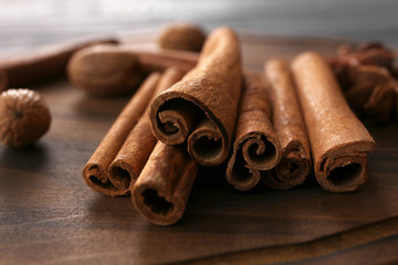 Closeup view of cinnamon sticks on wooden surface