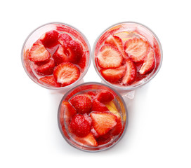 Three glasses of tasty strawberry lemonade on white background