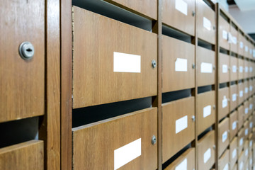 Wall of old wooden postal mailboxes and lockers in perspective view