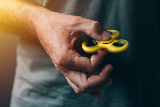 Man playing with fidget spinner