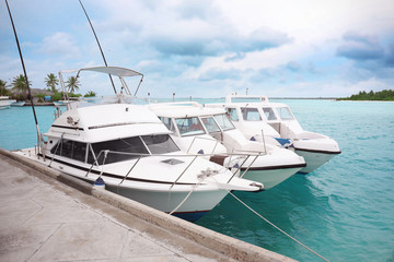 Fototapeta premium Berth with modern boats at tropical resort