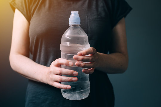 Woman with bottle of fresh drinking water