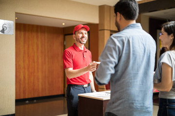 Man greeting customers at the movies