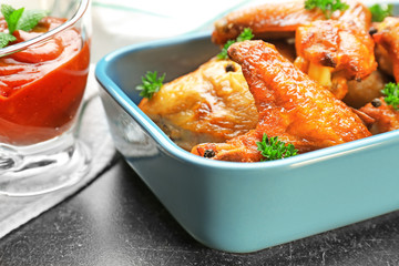 Delicious wings with sauce for chicken, closeup