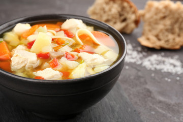 Homemade turkey soup in bowl on table