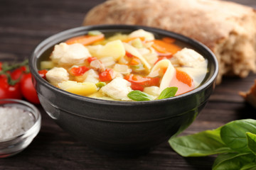 Homemade turkey soup in bowl on table