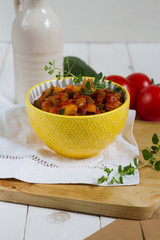 Leczo.Traditional hungarian stew or lecho with paprika,courgette and sausage. Served in a yellow bowl.