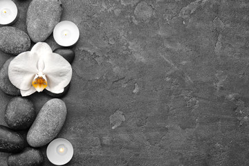 Fototapeta na wymiar Composition with beautiful white orchid and stones on grey background