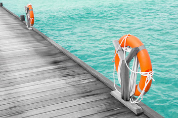 Wooden pontoon with flotation rings at sea resort