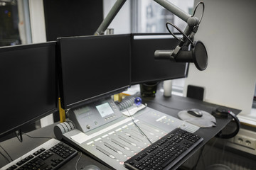 Monitors And Microphone Over Table In Radio Studio