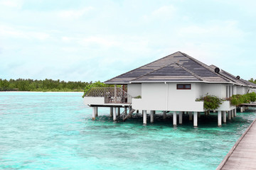 View of modern beach houses on piles at tropical resort