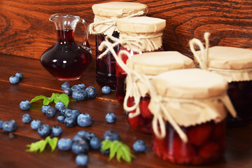 Fototapeta na wymiar Sweet blueberries and raspberries in jars for winter