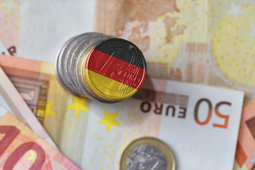 euro coin with national flag of germany on the euro money banknotes background. © luzitanija