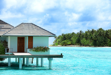 View of modern beach house on piles at tropical resort