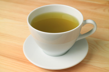 One Cup of Hot Green Tea Served on Natural Color Wooden Table 