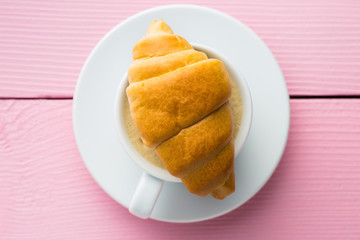Sweet tasty croissants and coffee cup.