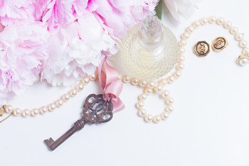 Skeleton key with peony flowers, glamour bottle and jewellery - love and wedding concept