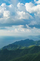 Fototapeta premium View of blue sky, sea and mountain seen from Cable Car viewpoint, Langkawi, Malaysia. Picturesque landscape with tropical forest, beaches, small Islands in waters of Strait of Malacca