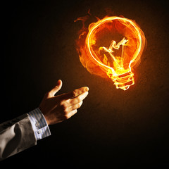 Concept of electricity or inspiration with burning light bulb