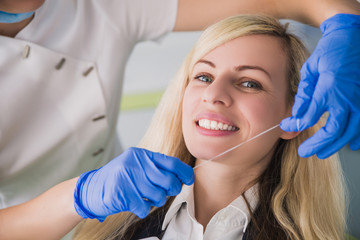 dantist teach cleaning teeth with dental floss, perfect healthy tooth