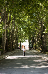Young woman walking through park in Porto, Portugal