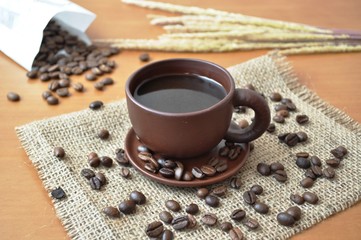 Coffee beans and a cup of coffee on the table