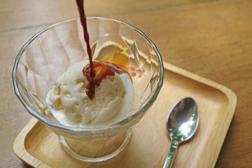 Start pouring espresso coffee onto vanilla ice cream for a tasty Affogato 