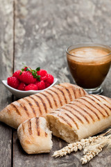 homemade  fresh panini bread with cup of cappuccino and raspberries