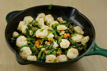 Making shrimp and vegetable stir fry in cast ion frying pan skillet