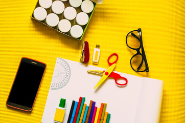 Desktop. Scissors and stationery. Phone for viewing