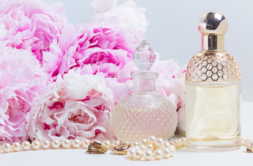 Wedding lifestyle with fresh pink peony flowers, glamour bottles and jewellery close up
