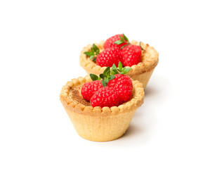 egg  custard tarts with raspberries isolated on white