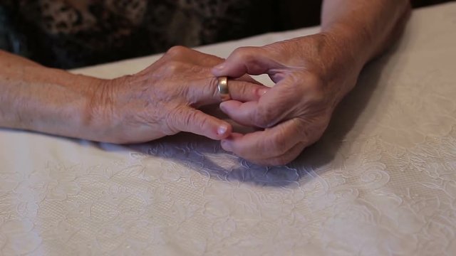 The old woman removing an engagement ring from a finger