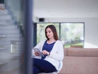 young women using tablet computer by the window