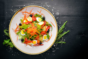 Vegetable salad with chicken eggs. On a wooden background. Top view. Free space for your text.
