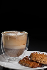 Coffee and biscuits. Cappuccino in glass mug with home made cookies.