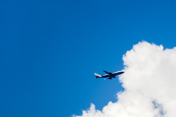 Airplane at fly on the sky with clouds