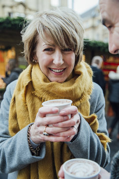 Mature Woman Drinking Hot Chocolate at Christmas Market