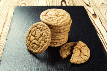 Biscuit sweet cookie background. Domestic stacked butter biscuit pattern concept,close up macro.Homemade cookies on wooden table.Cereal biscuits with the sesame,peanuts,sunflower and amaranth.