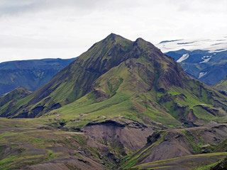 thorsmork national park in iceland  - green mountain with steep path and ice