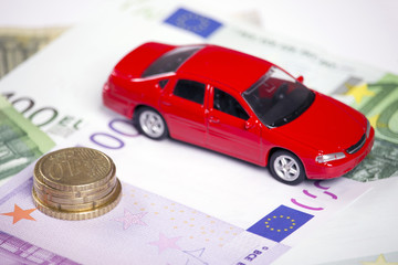 Euro banknotes and car model